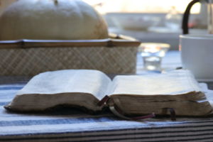An open Bible spread open on a table.