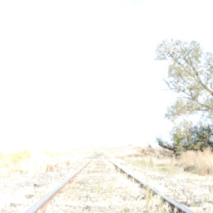 Railroad track to bright light.