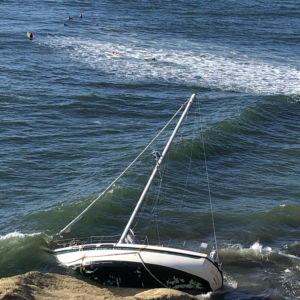 Sailboat grounded on Pacific Ocean Coast