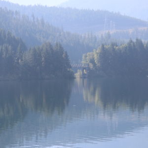 Beautiful lake, with it's reflections of trees and foothills creating a soothing image.